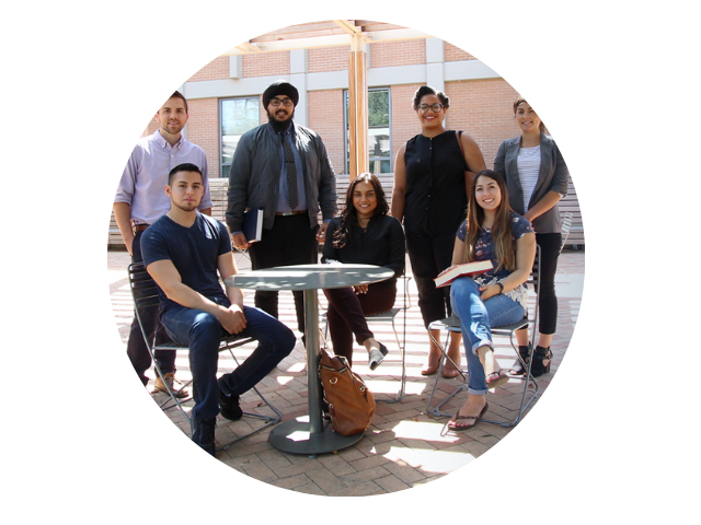 Group of law students huddle together to smile for photo